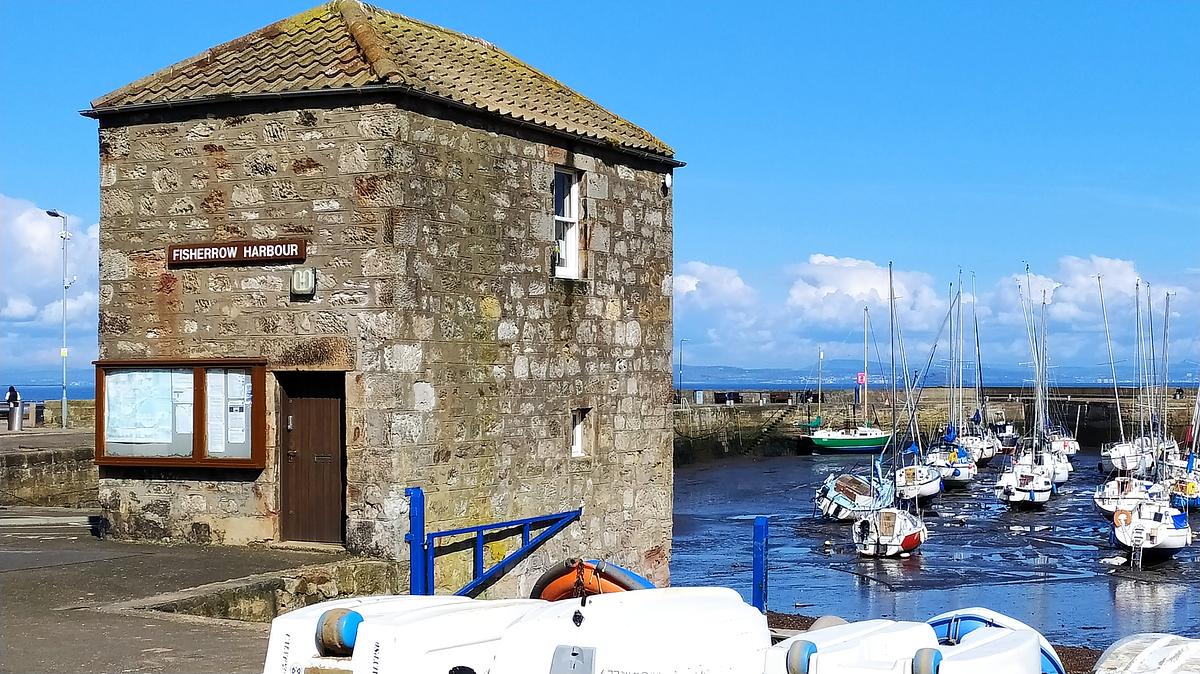 Fisherrow Harbour Office, a stone building by the Fisherrow Harbour car park with a brown door